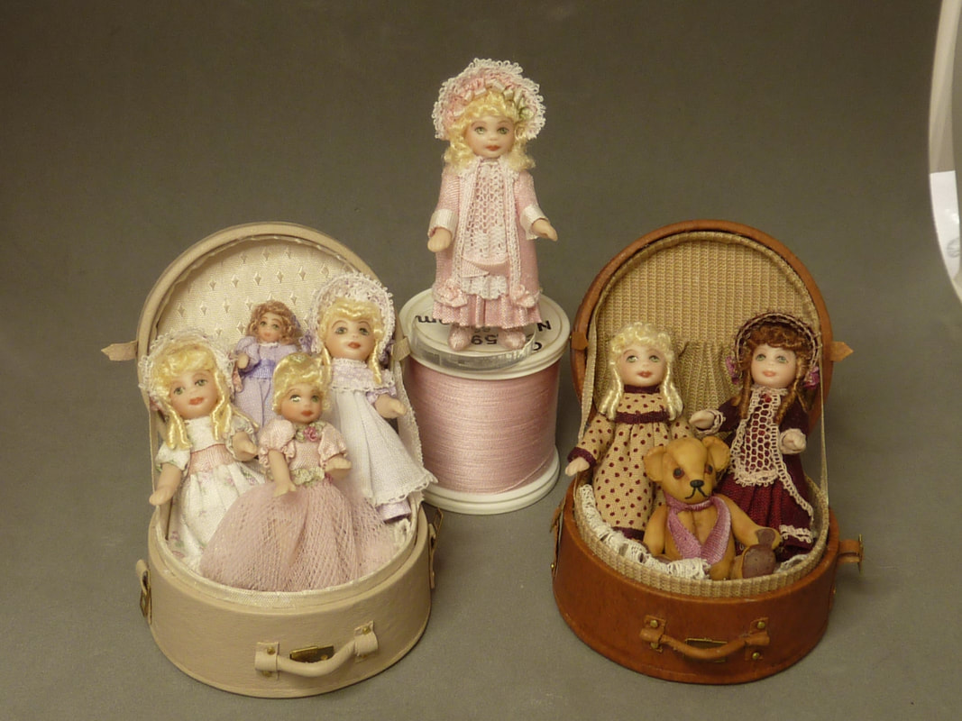 Multiple dolls in a hat box